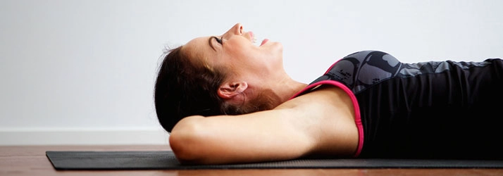Chiropractic Albertville MN Woman Stretching On Mat