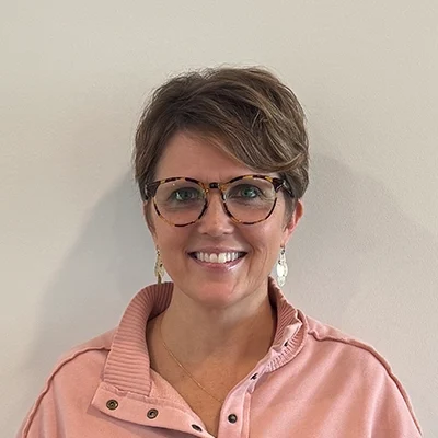 Team Member Alicia Blakstvedt Smiling In Pink Top