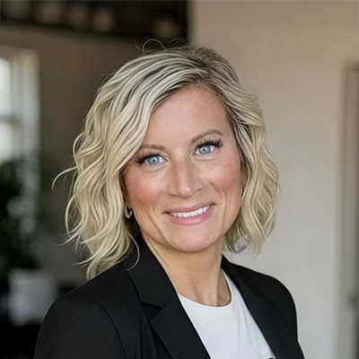 Mindset Coach Carrie Cotch Smiling In Front Of Blurred Background